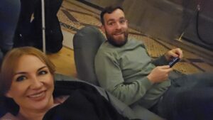 Couple lying on beanbags at Eonarium light show in the great hall of St Georges Hall.