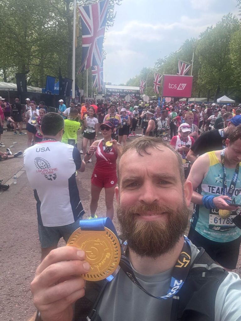 selfie of man holding medal