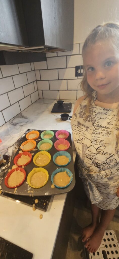 image of girl with cake mixture in cake tin